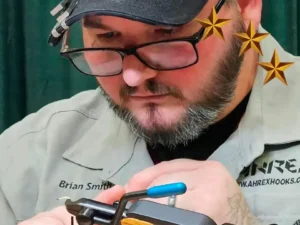 Brian Smith in action in front of his vise, tying flies.